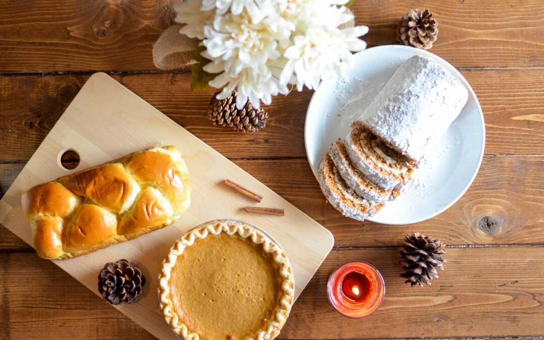 Thanksgiving pie, pastry, and bread roll on a table