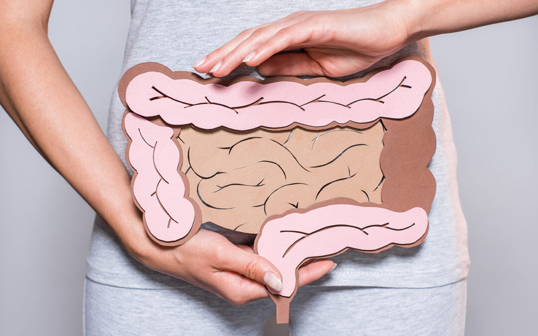 woman holding drawing of intestine on her stomach